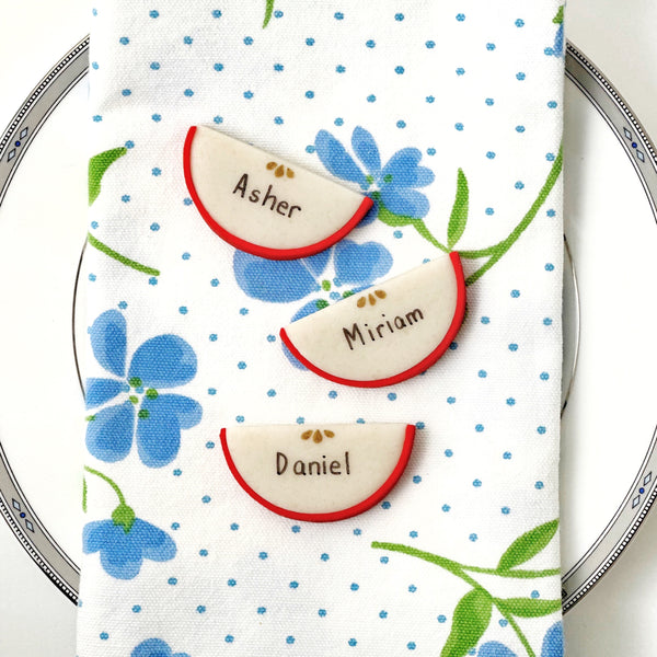 rosh hashanah personalized marzipan apple slices on a napkinrosh hashanah personalized marzipan apple slices dinner table settings on a napkin