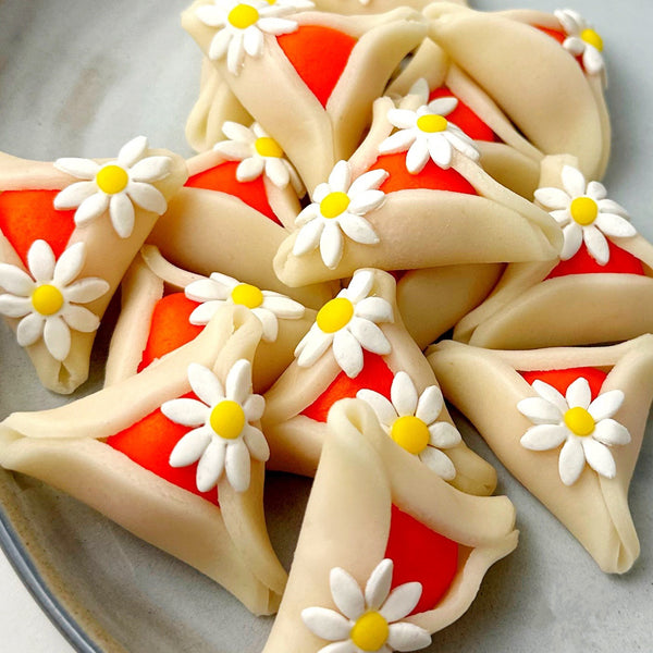 purim daisy hamantaschen piled up