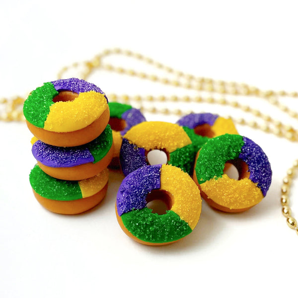 mardi gras mini king cakes with gold beads in background