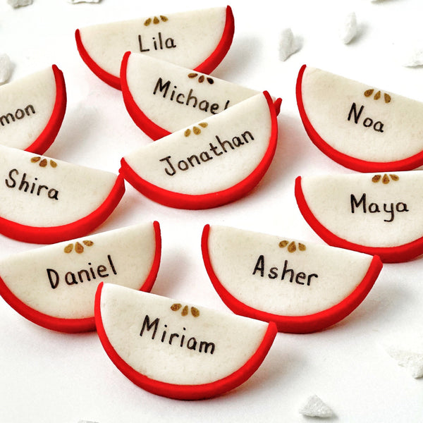 rosh hashanah personalized marzipan apple slices dinner table settings closeup