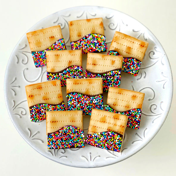 passover seder rainbow sprinkle matzah tiles on a round plate