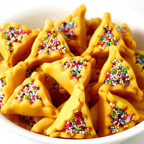 Purim vegan gluten-free purim sprinkle hamantaschen marzipan candy sculpture treats in a bowl closeup