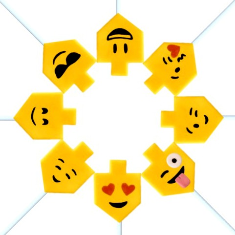 Hanukkah emoji yellow dreidels in a circle marzipan candy lollipops