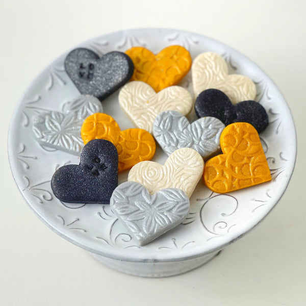 valentine's day elegant gold silver marzipan hearts on a plate