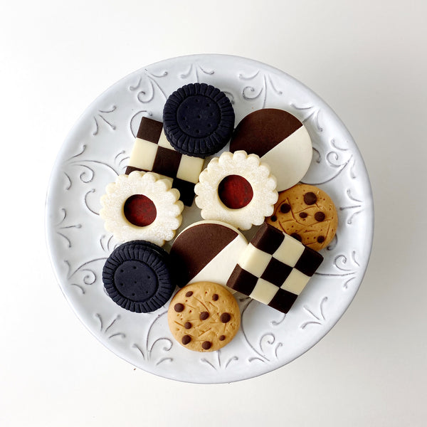 assorted cookies marzipan candy sculpture treats on a plate