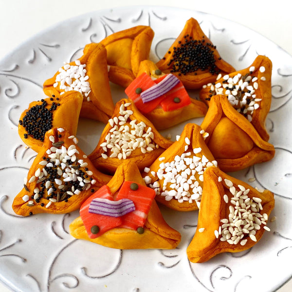 purim hamantaschen marzipan bagels on a plate