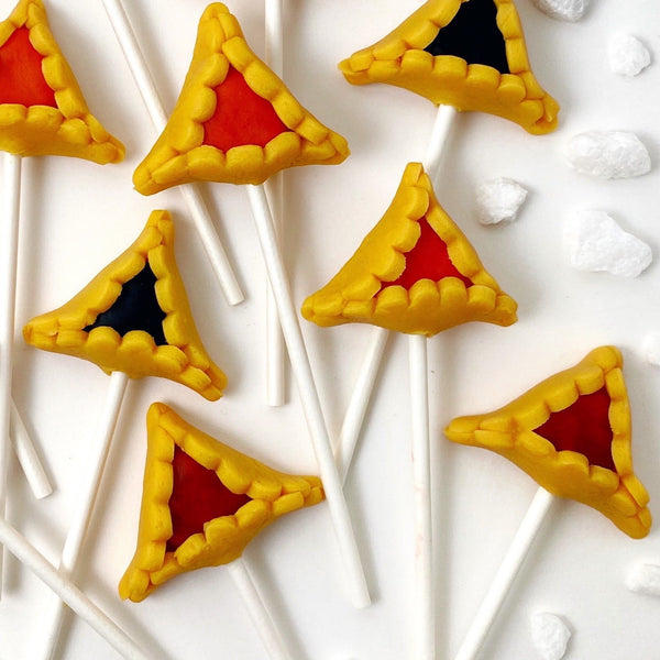 Purim vegan gluten-free assorted hamantaschen marzipan candy lollipops closeup