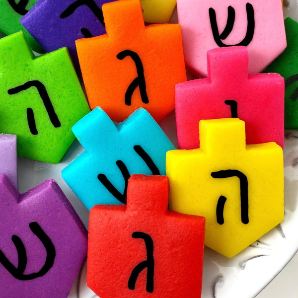 Hanukkah rainbow dreidels marzipan candy tiles on a plate