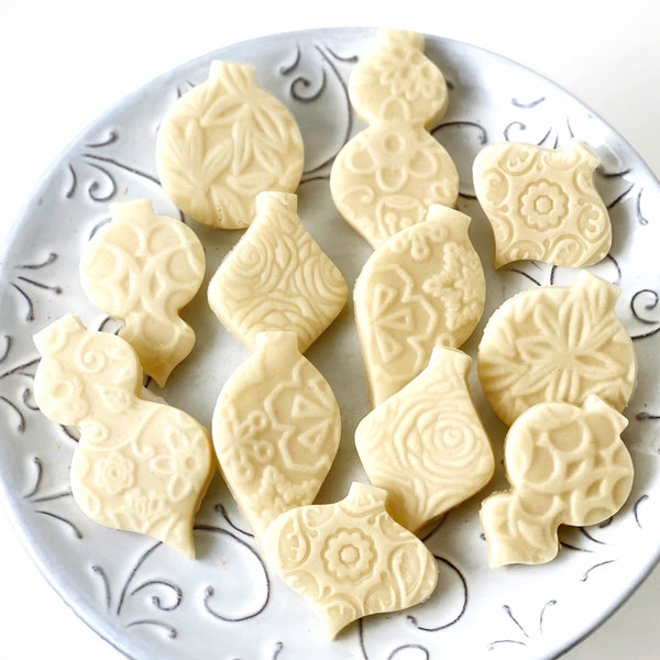 naked marzipan christmas ornaments on a plate