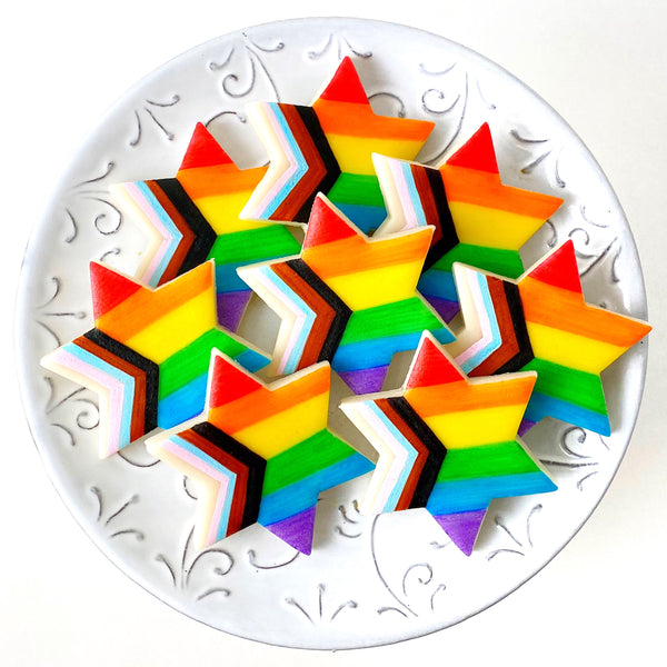rainbow progress pride stars of David marzipan candy tiles on a plate