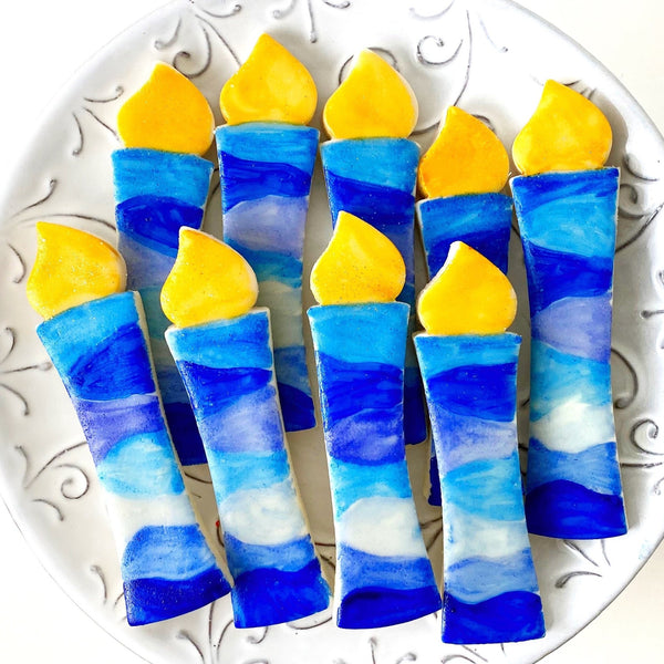 hanukkah blue menorah candles marzipan candy on a plate