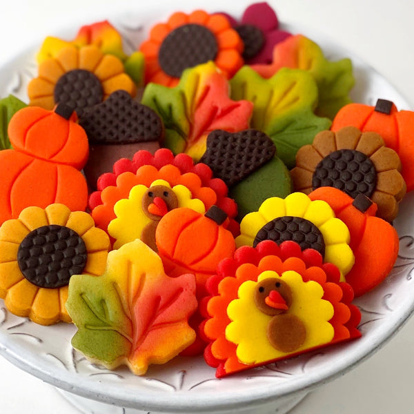 Thanksgiving pumpkin turkey acorn leaves sunflowers marzipan candy gift basket on a plate