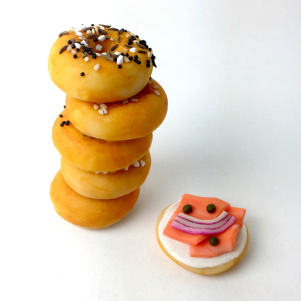 mini bagels with poppy, sesame and lox marzipan candy sculpture treats in a stack
