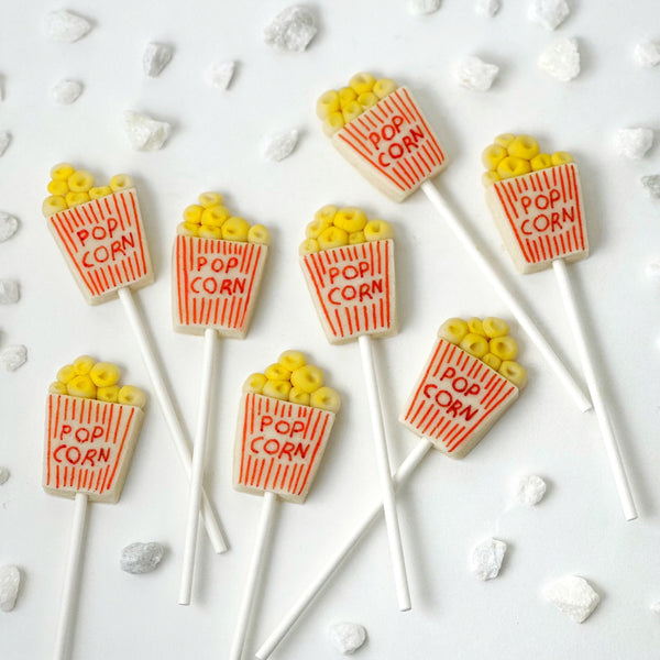 movie popcorn box marzipan candy lollipops flatlay