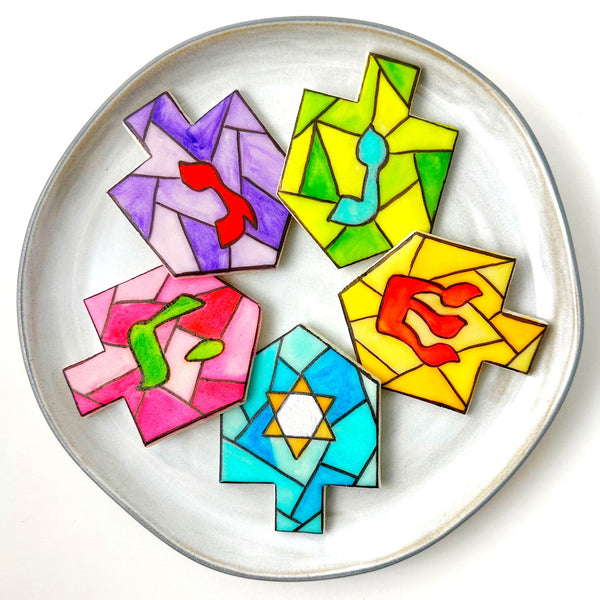 stained glass Hanukkah dreidels on a plate