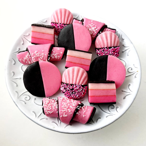 pink marzipan cookies on a plate