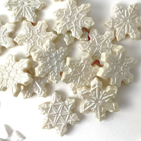 Christmas winter snowflake marzipan candy tiles in a pile closeup