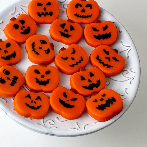 Halloween jack 'o' lantern marzipan candy tiles on a plate