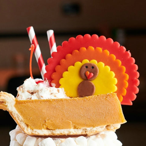 giant Thanksgiving turkeys marzipan candy lollipops in a milkshake closeup