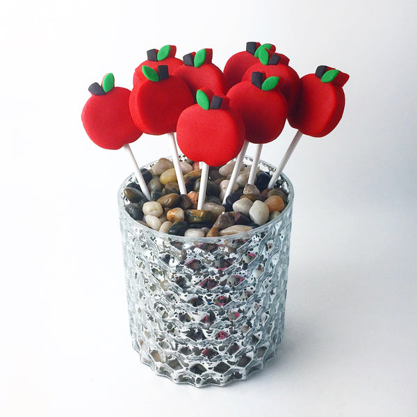 Rosh Hashanah red apples in a vase marzipan candy lollipops
