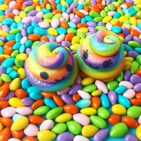 pair of kawaii rainbow unicorn poops marzipan candy sculpture treats with happy faces