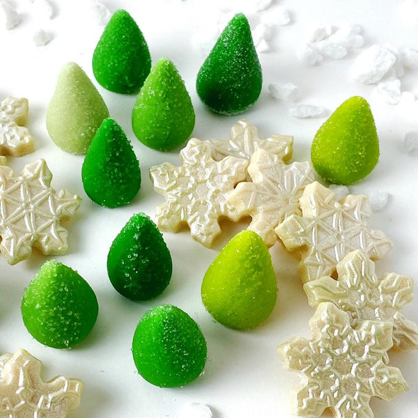sparkly snowflakes and green trees marzipan candy sculpture treats close up