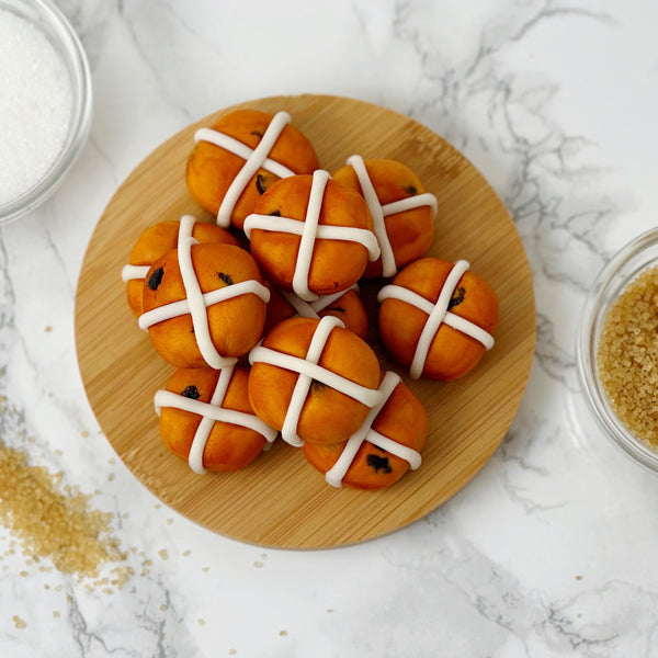 marzipan hot cross buns stacked and styled