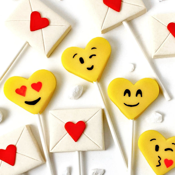 Valentine's Day yellow emoji hearts and love letters marzipan candy lollipops close up