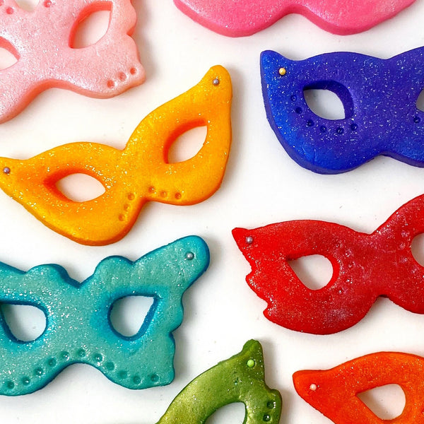 Purim rainbow glitter masks marzipan candy treats closeup