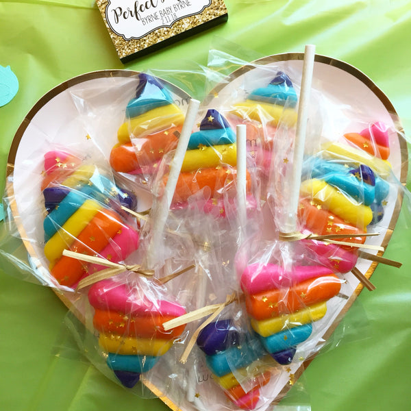 rainbow unicorn poop with gold stars candid shot marzipan candy lollipops