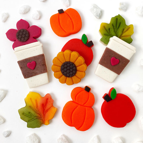 Autumn collection with pumpkins, coffee cups, flowers, maple leaves and apples marzipan candy tiles