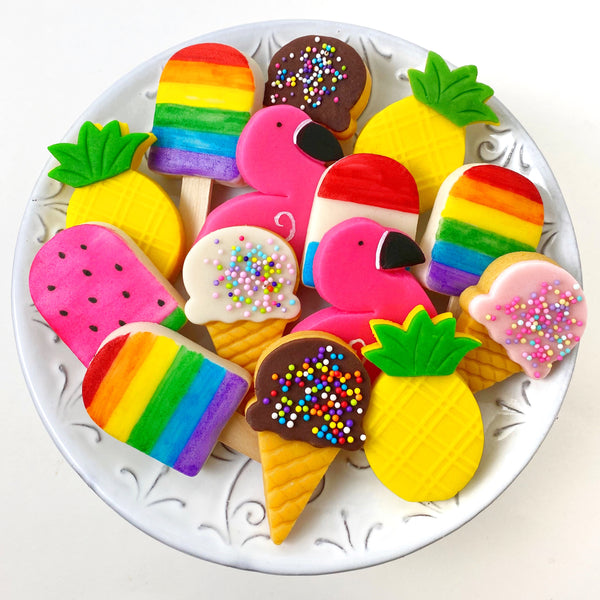 summer tropical marzipan candy treats with flamingos, pineapples, ice cream cones popsicles on a plate