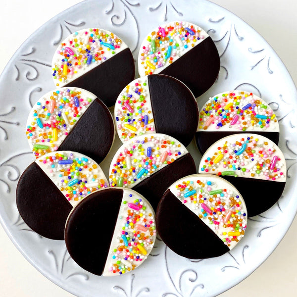 sprinkle black white marzipan candy cookies on a plate