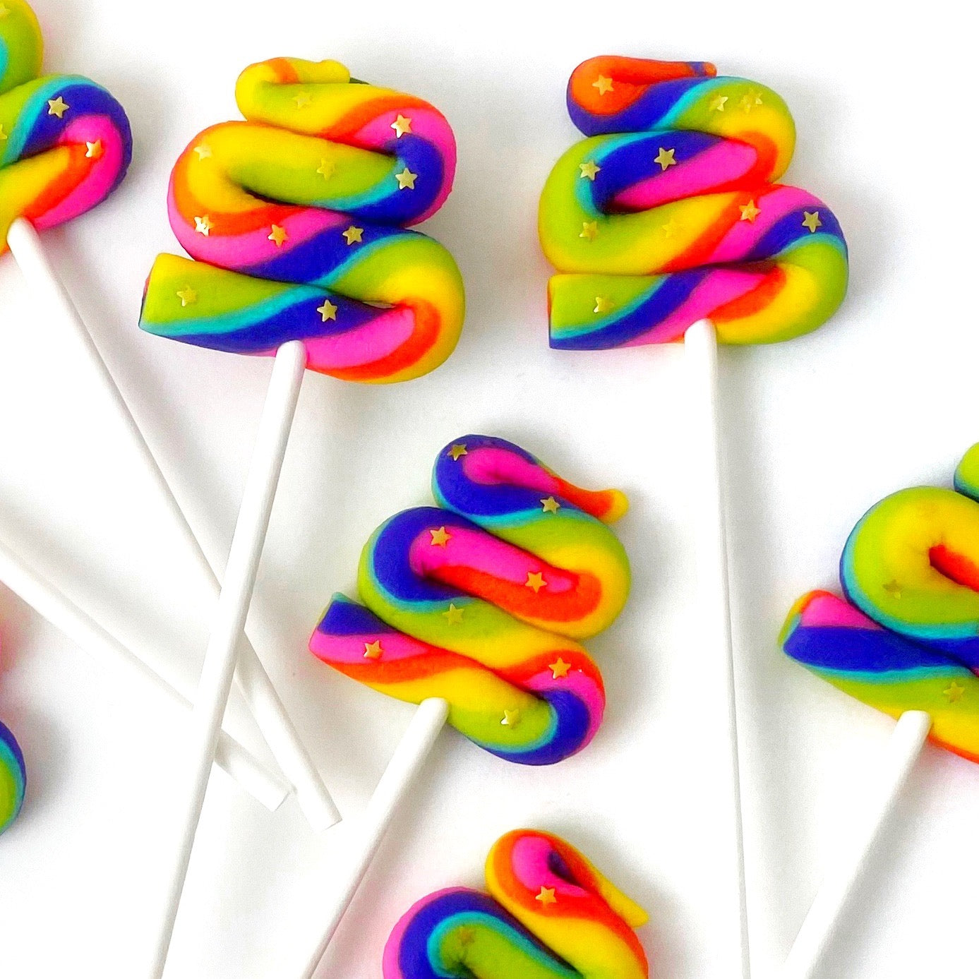 unicorn poop rainbow marzipan candy lollipops closeup