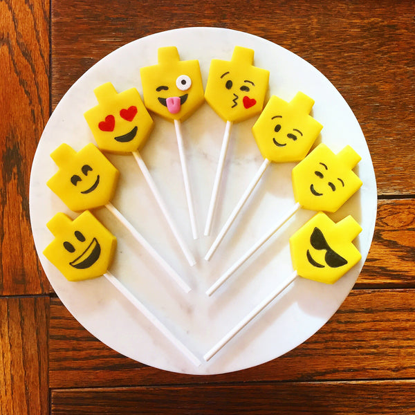 Hanukkah emoji yellow dreidels candid shot marzipan candy lollipops