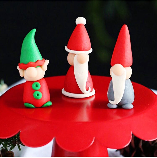Christmas gnome, santa and elf trio marzipan candy sculpture treats on a cakestand
