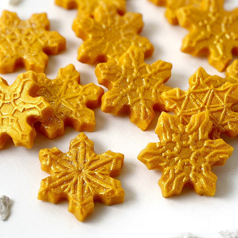 gold snowflake marzipan candy tiles closeup