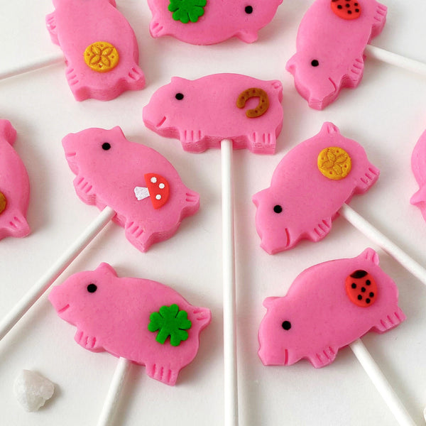 marzipan pigs Christmas glucksschwein pink candy lollipops for good luck closeup