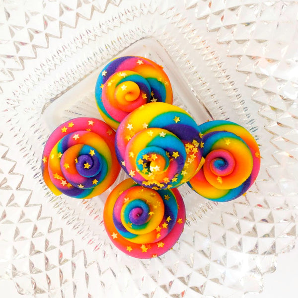 rainbow unicorn poop marzipan candy sculpture treats on a glass plate