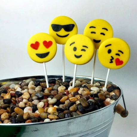 yellow emoji marzipan candy lollipops in a planter